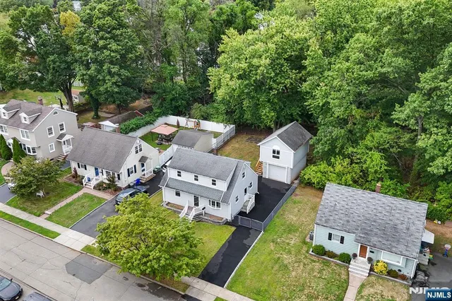 an aerial view of a house with swimming pool garden and patio