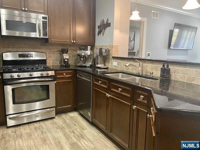 54 Polifly Road, Unit 104 Hackensack, NJ 07601 - Photo 3 of 11 a kitchen with granite countertop a sink stainless steel appliances and cabinets