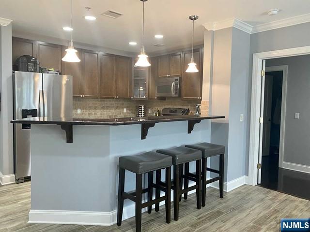 54 Polifly Road, Unit 104 Hackensack, NJ 07601 - Photo 4 of 11 a kitchen with kitchen island granite countertop a sink and refrigerator