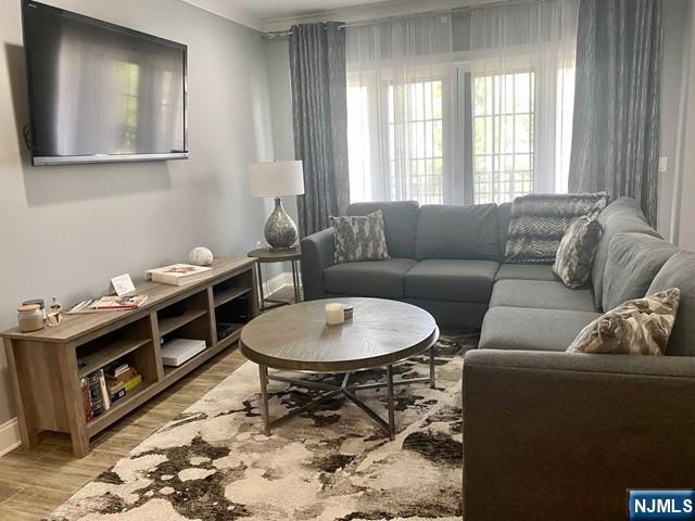 54 Polifly Road, Unit 104 Hackensack, NJ 07601 - Photo 5 of 11 a living room with furniture and a window