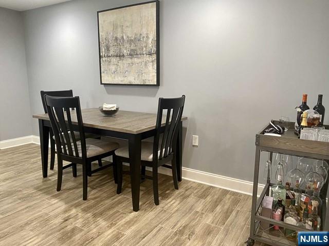 54 Polifly Road, Unit 104 Hackensack, NJ 07601 - Photo 7 of 11 a view of a dining room with furniture and wooden floor