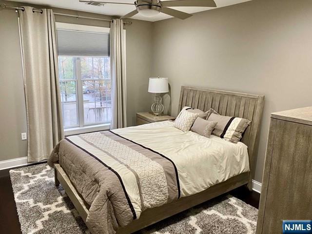 54 Polifly Road, Unit 104 Hackensack, NJ 07601 - Photo 9 of 11 a large bed sitting in a bedroom next to a window