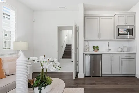 a bedroom with a sink and a washer dryer