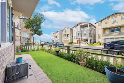 a kitchen with stainless steel appliances granite countertop a sink a stove a refrigerator and island with wooden floor