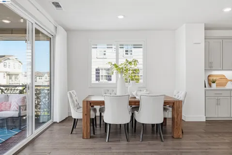 a living room with furniture kitchen and a table