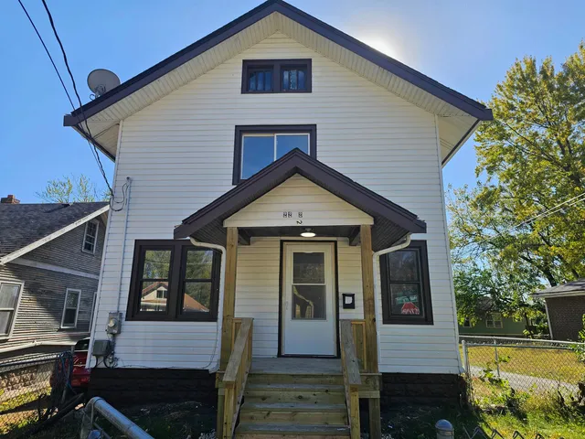 a view of a house with wooden fence