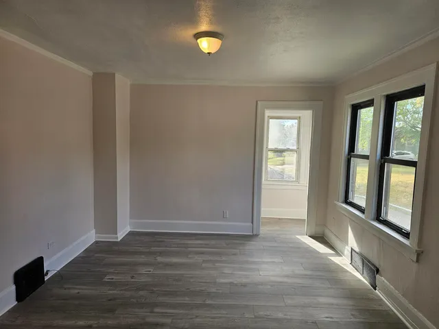 wooden floor in an empty room with a window