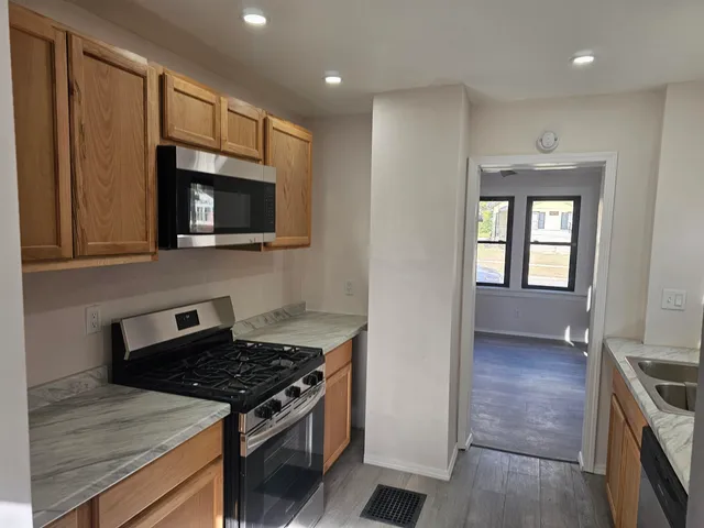 a kitchen with stainless steel appliances a stove a microwave and cabinets