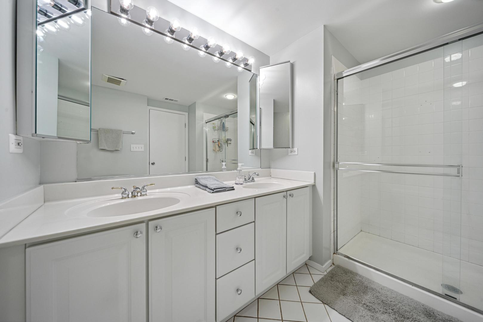 811 South Lytle Street, Unit 510 Chicago, IL 60607 - Photo 15 of 26 a bathroom with a double vanity sink mirror and shower