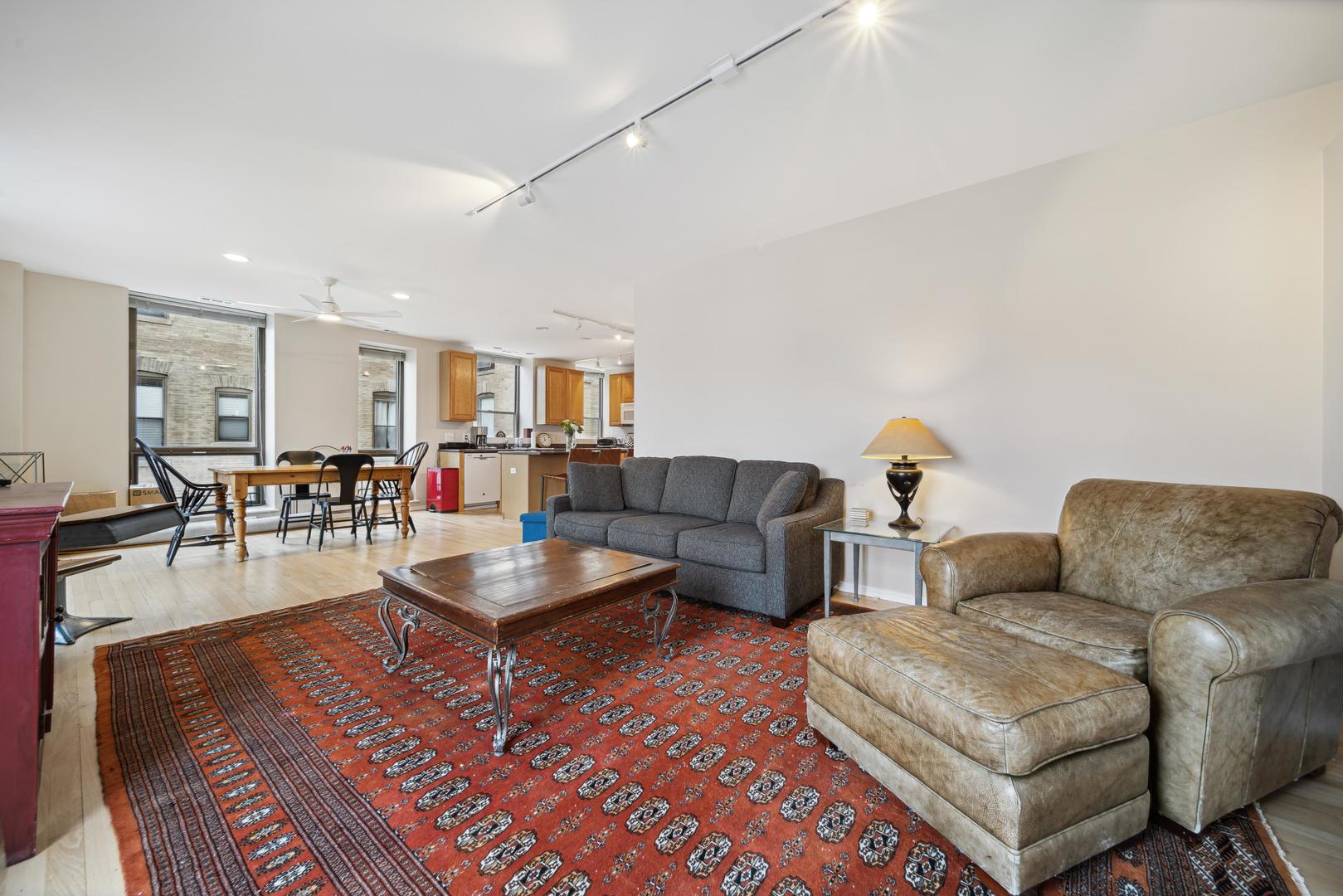 811 South Lytle Street, Unit 510 Chicago, IL 60607 - Photo 3 of 26 a living room with furniture and wooden floor
