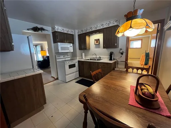 a kitchen with sink refrigerator and stove