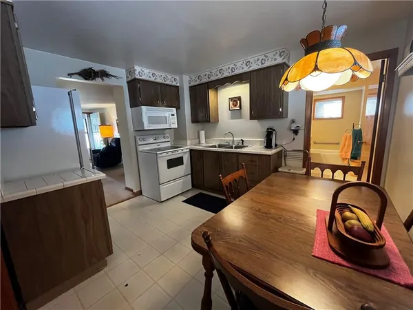 a kitchen with sink refrigerator and stove