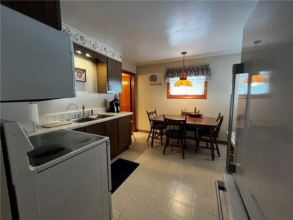 a kitchen with a stove and chairs