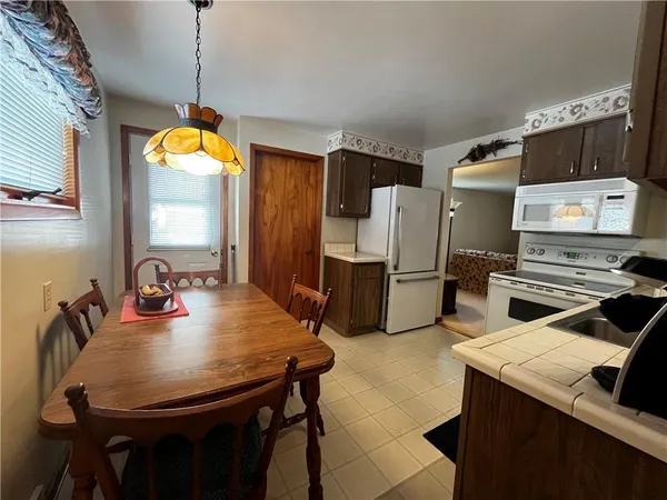 a kitchen with stainless steel appliances granite countertop a sink a stove and a refrigerator