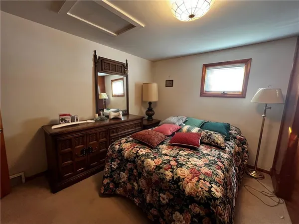 a bedroom with a bed and a mirror