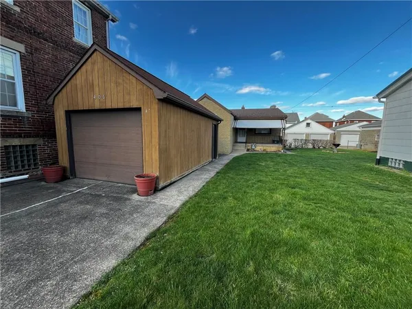 a front view of house with yard and green space