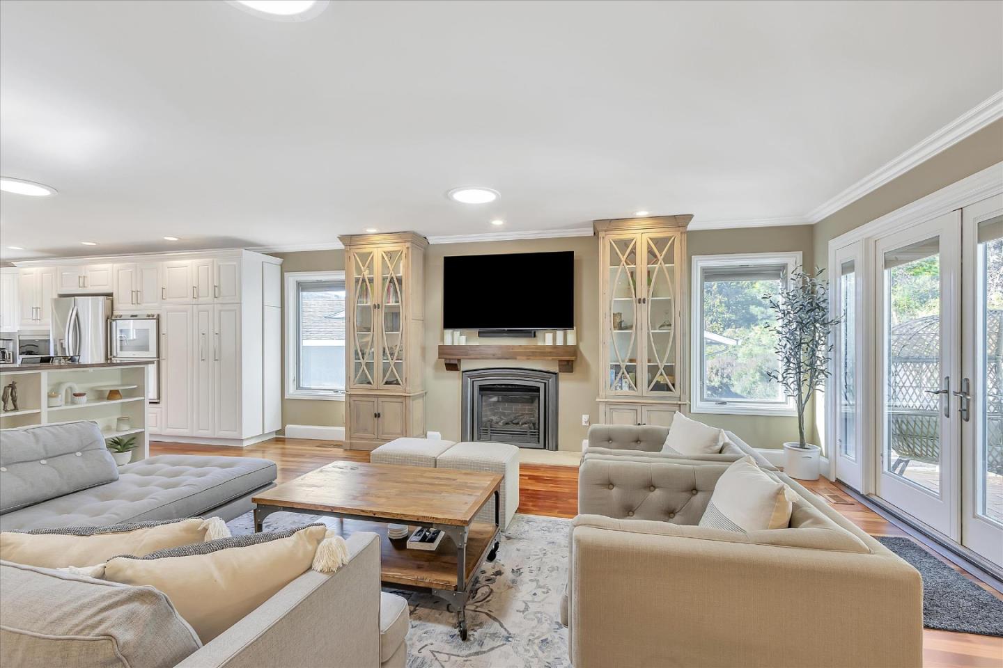 1261 Oddstad Boulevard Pacifica, CA 94044 - Photo 17 of 62 a living room with furniture a fireplace and a flat screen tv