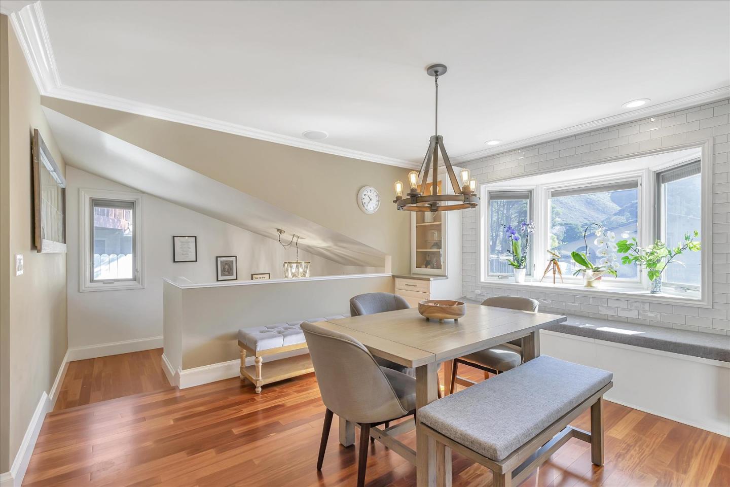 1261 Oddstad Boulevard Pacifica, CA 94044 - Photo 19 of 62 a dining room with furniture a chandelier and wooden floor