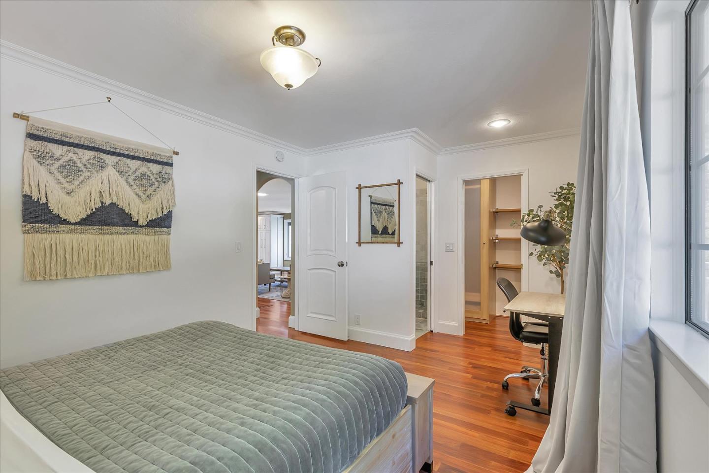 1261 Oddstad Boulevard Pacifica, CA 94044 - Photo 29 of 62 a bedroom with a bed and a painting on the wall