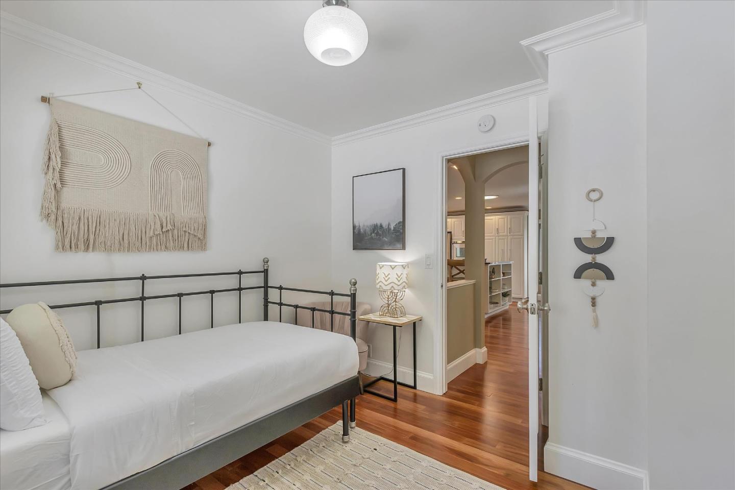 1261 Oddstad Boulevard Pacifica, CA 94044 - Photo 31 of 62 a bedroom with a bed and a chandelier