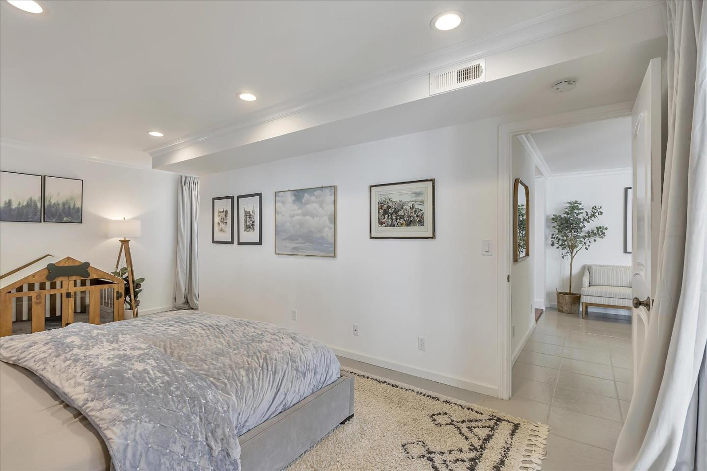 1261 Oddstad Boulevard Pacifica, CA 94044 - Photo 35 of 62 a bedroom with a large bed and a walk in closet