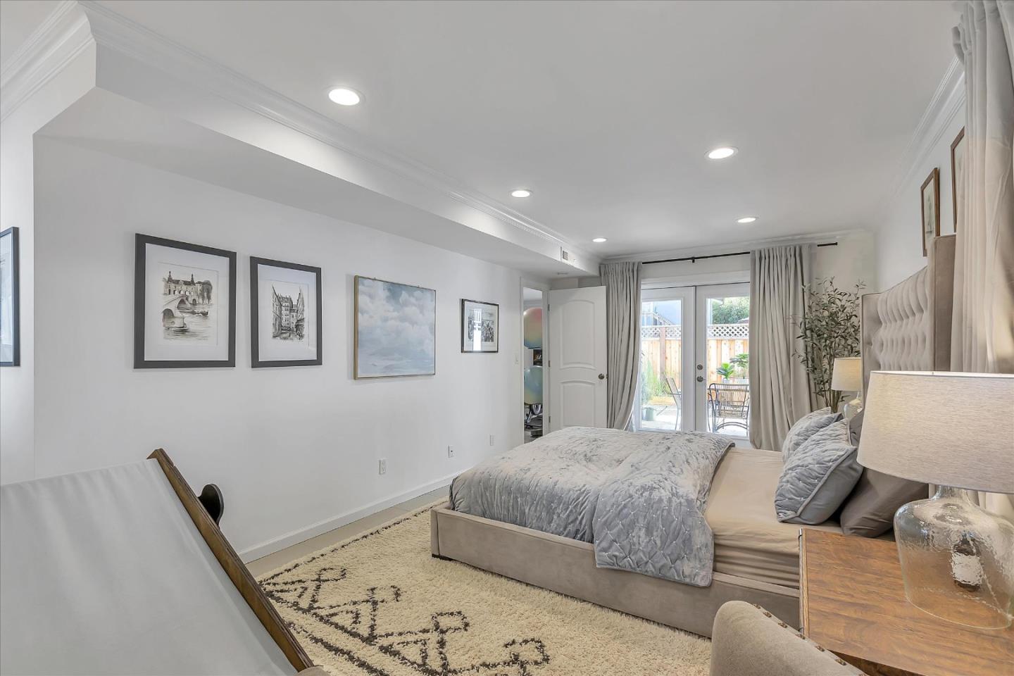 1261 Oddstad Boulevard Pacifica, CA 94044 - Photo 37 of 62 a spacious bedroom with a bed a couch and a window