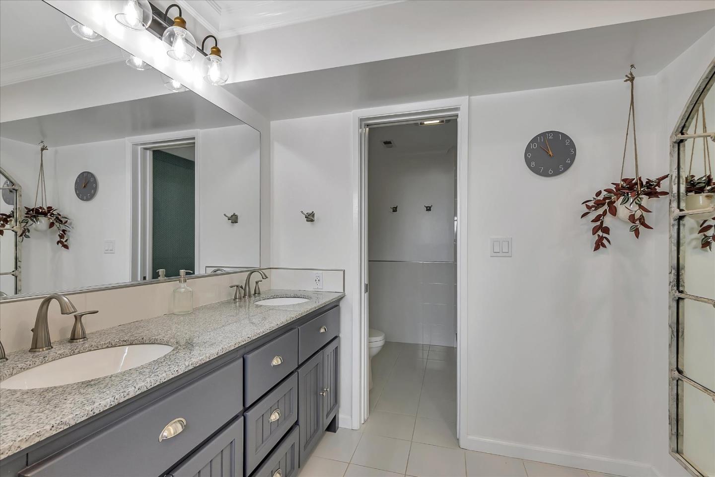 1261 Oddstad Boulevard Pacifica, CA 94044 - Photo 43 of 62 a bathroom with a granite countertop sink and a mirror