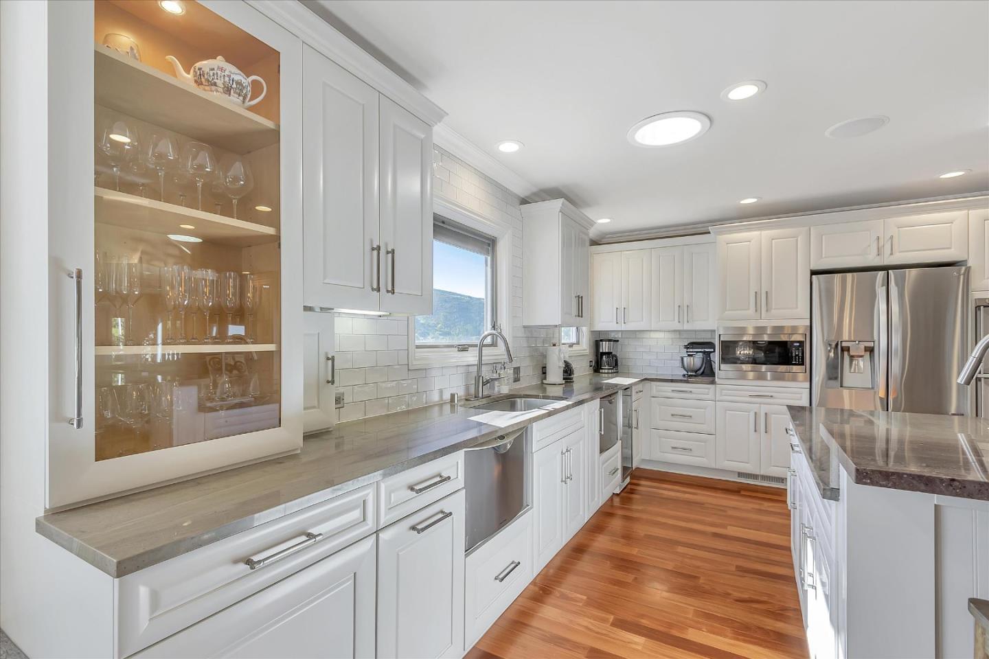 1261 Oddstad Boulevard Pacifica, CA 94044 - Photo 6 of 62 a large kitchen with stainless steel appliances kitchen island granite countertop a refrigerator and cabinets