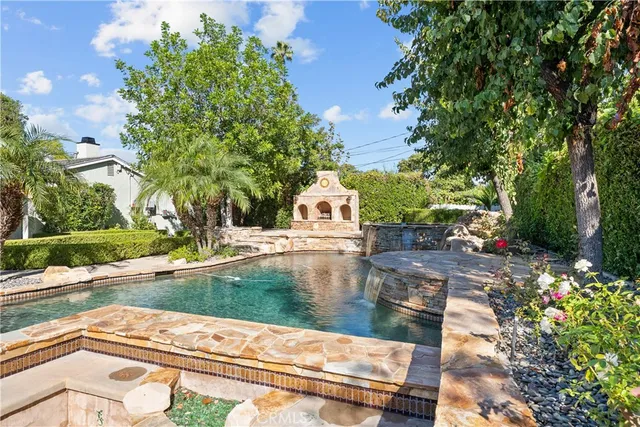a kitchen with stainless steel appliances granite countertop a stove and white cabinets