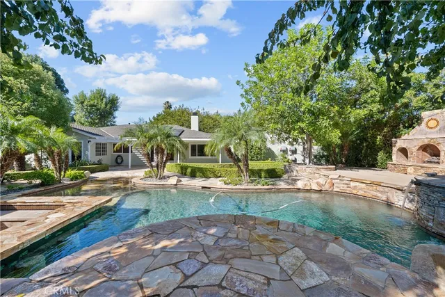 a bathroom with a granite countertop sink a mirror a vanity and a shower