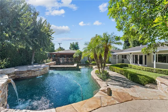 an aerial view of a house with swimming pool and outdoor space