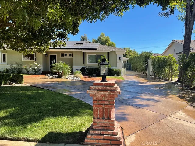 a view of a patio with a table and chairs under an umbrella