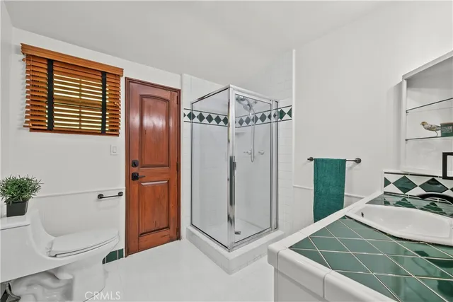 a kitchen with granite countertop white cabinets and a window