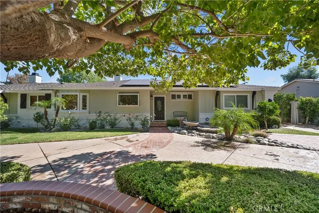 a table and chair under an umbrella
