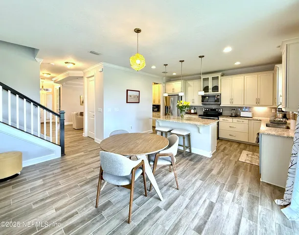 a white bed sitting in a bedroom next to a couch