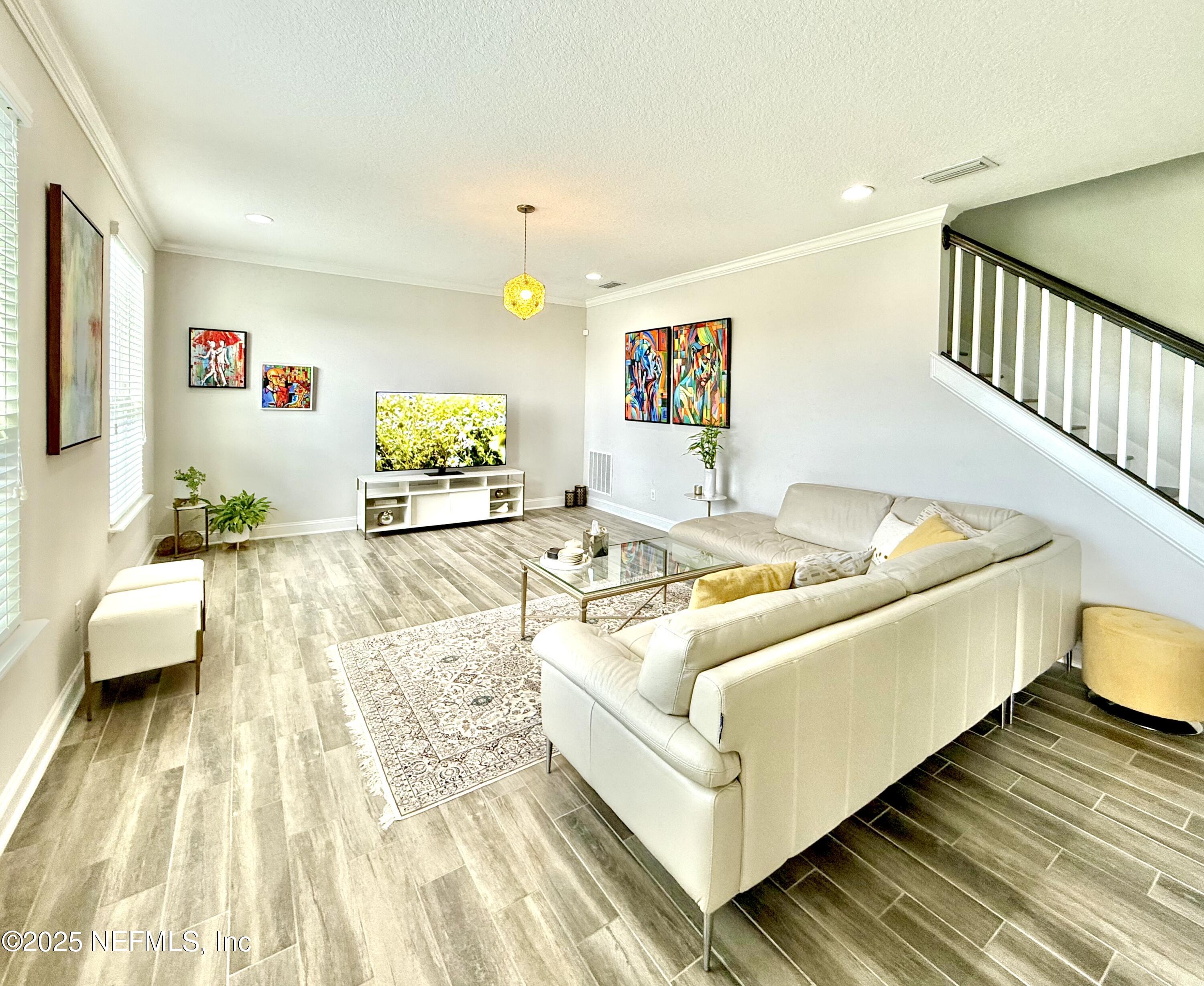 6887 Azalea Grove Drive Jacksonville, FL 32258 - Photo 13 of 35 a white bed sitting in a bedroom next to a couch