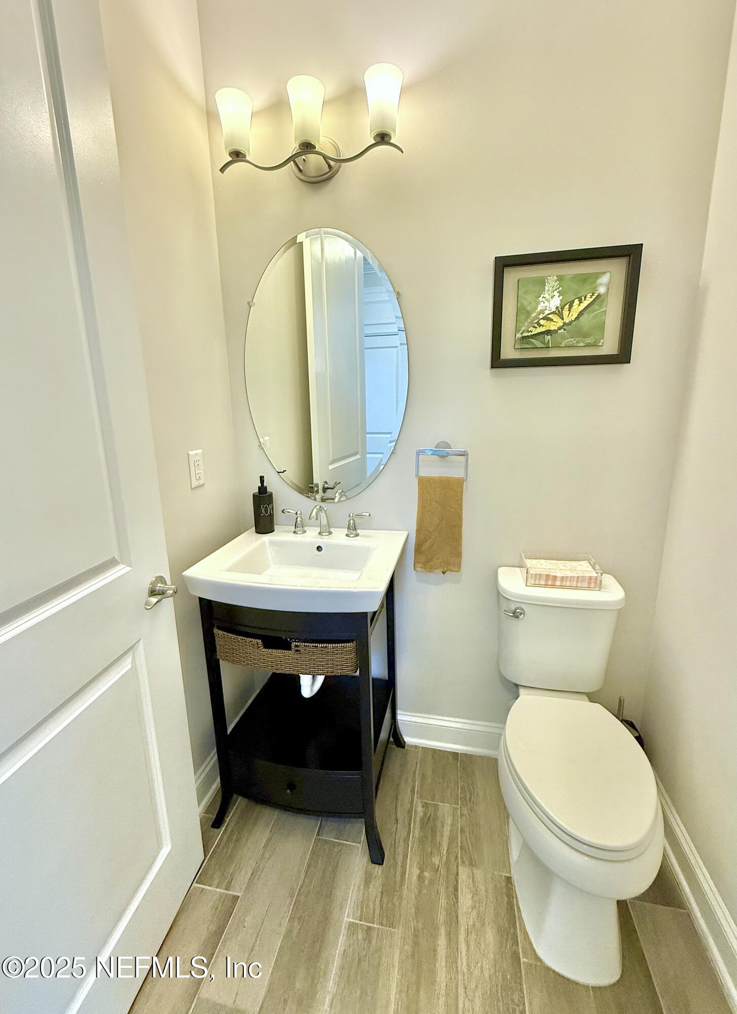 6887 Azalea Grove Drive Jacksonville, FL 32258 - Photo 16 of 35 a bathroom with a sink a toilet and mirror
