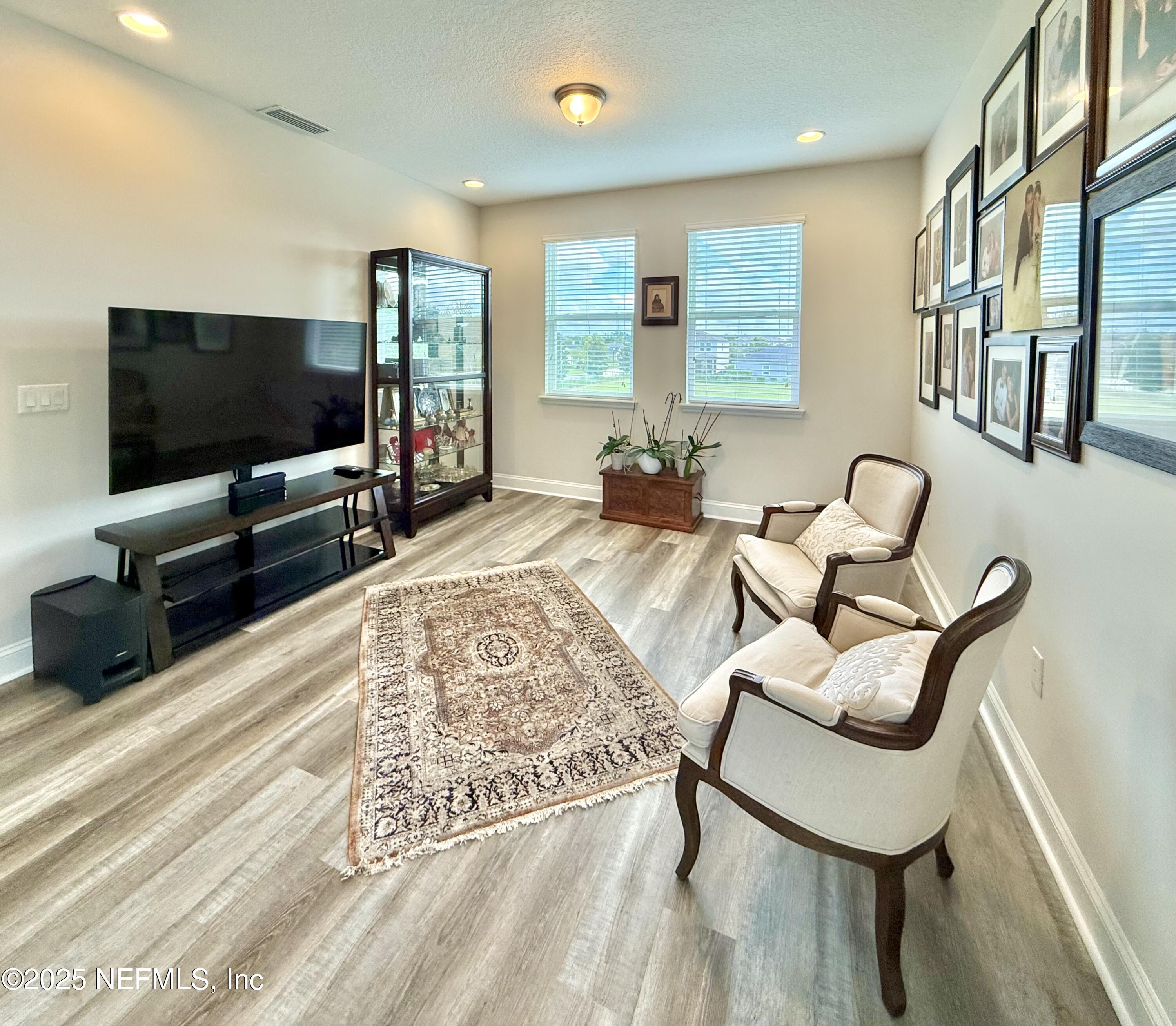 6887 Azalea Grove Drive Jacksonville, FL 32258 - Photo 17 of 35 a living room with furniture and a flat screen tv
