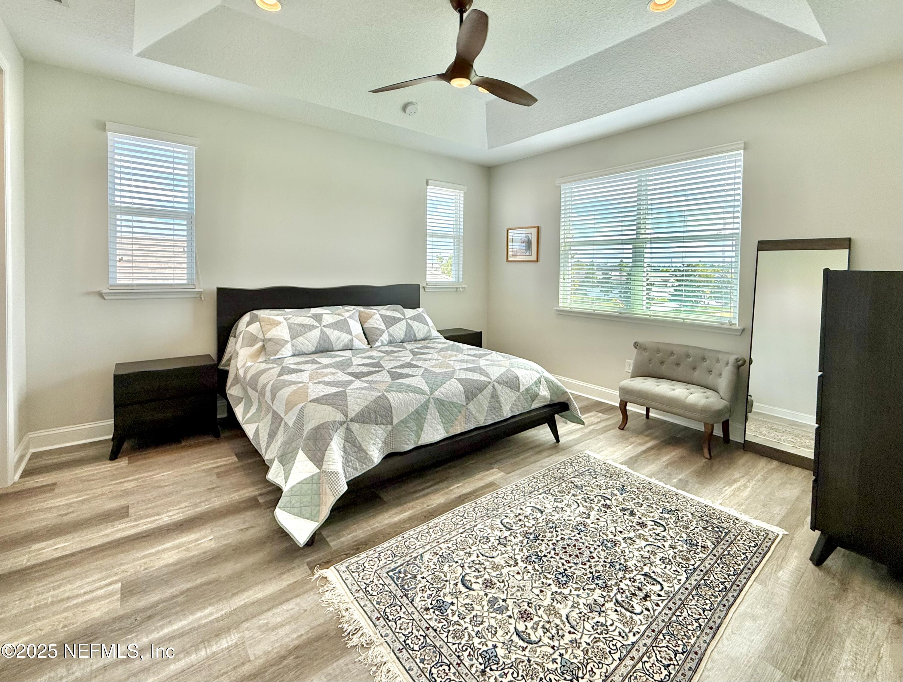 6887 Azalea Grove Drive Jacksonville, FL 32258 - Photo 18 of 35 a bedroom with a bed couch and a window