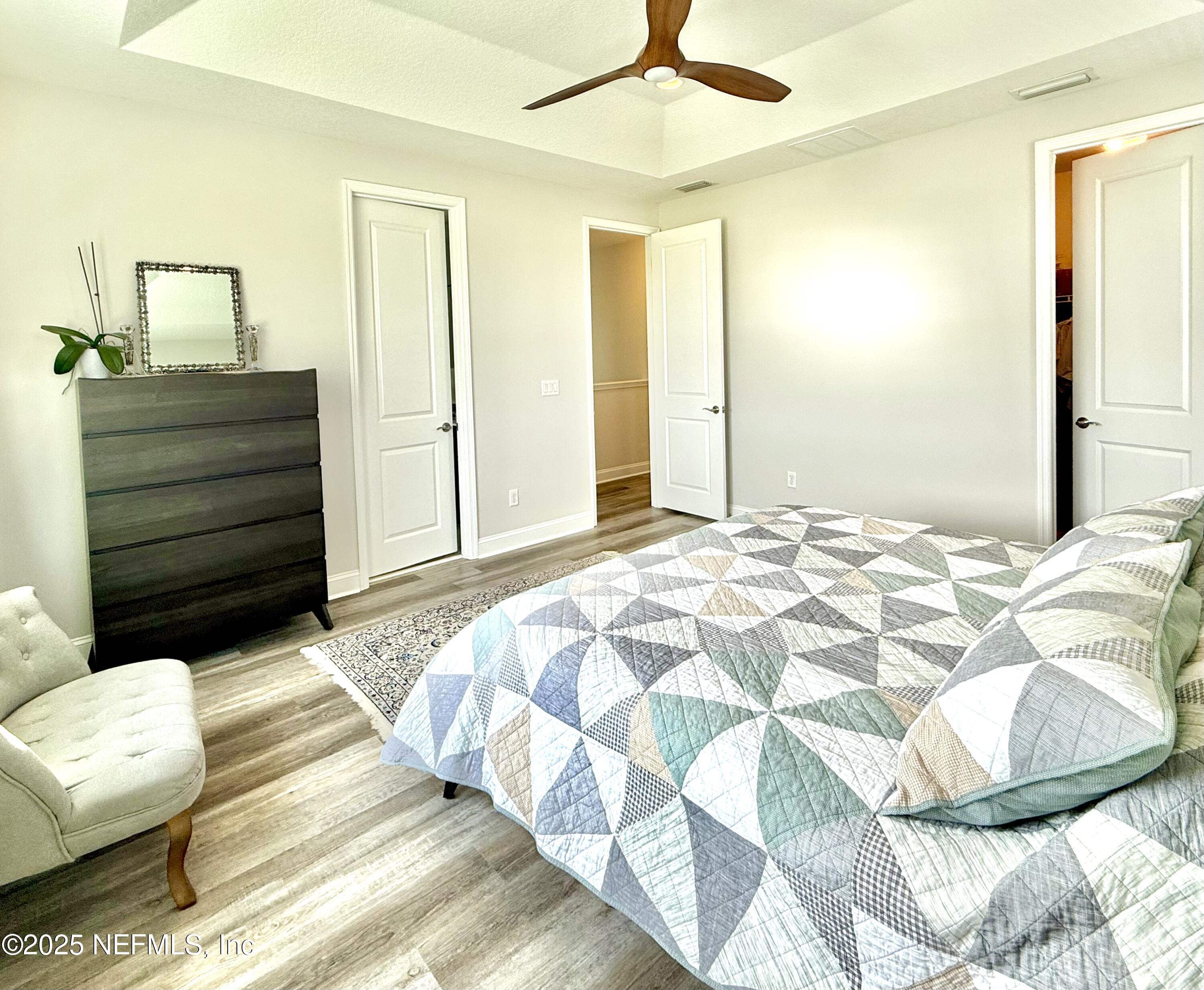 6887 Azalea Grove Drive Jacksonville, FL 32258 - Photo 19 of 35 a bedroom with a bed and a mirror