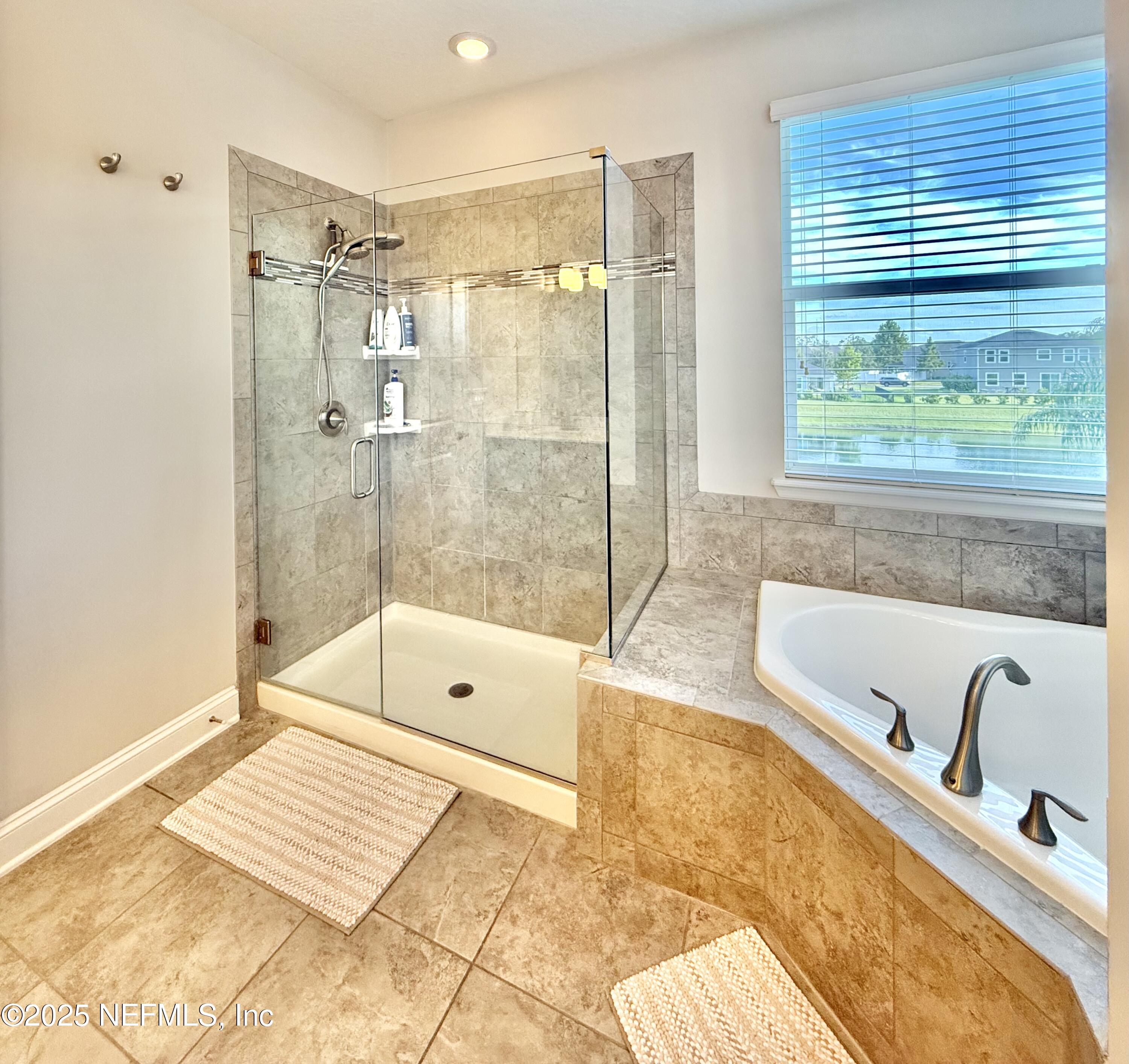 6887 Azalea Grove Drive Jacksonville, FL 32258 - Photo 20 of 35 a bathroom with a tub a sink and a shower