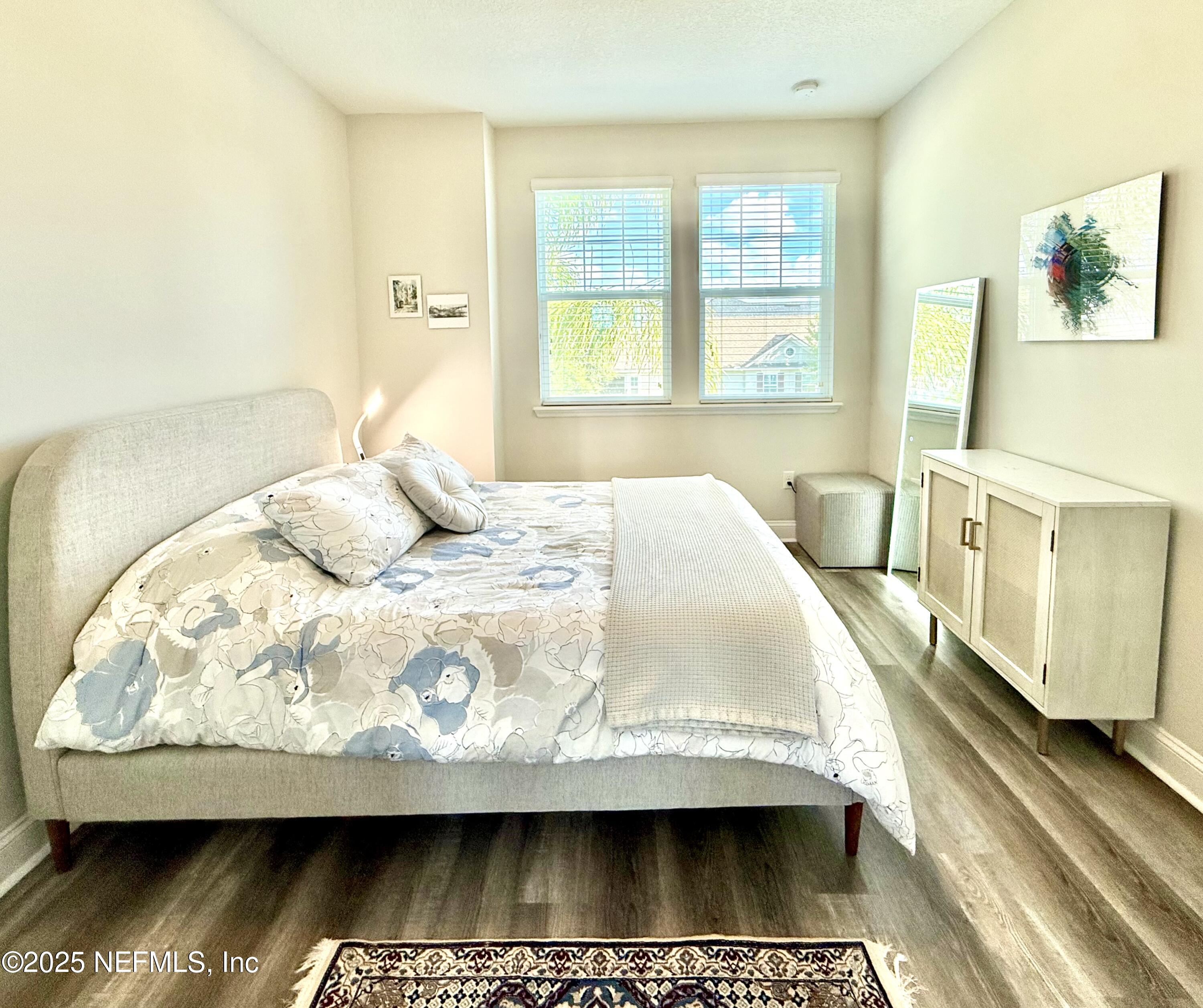 6887 Azalea Grove Drive Jacksonville, FL 32258 - Photo 24 of 35 a bedroom with a bed and wooden floor