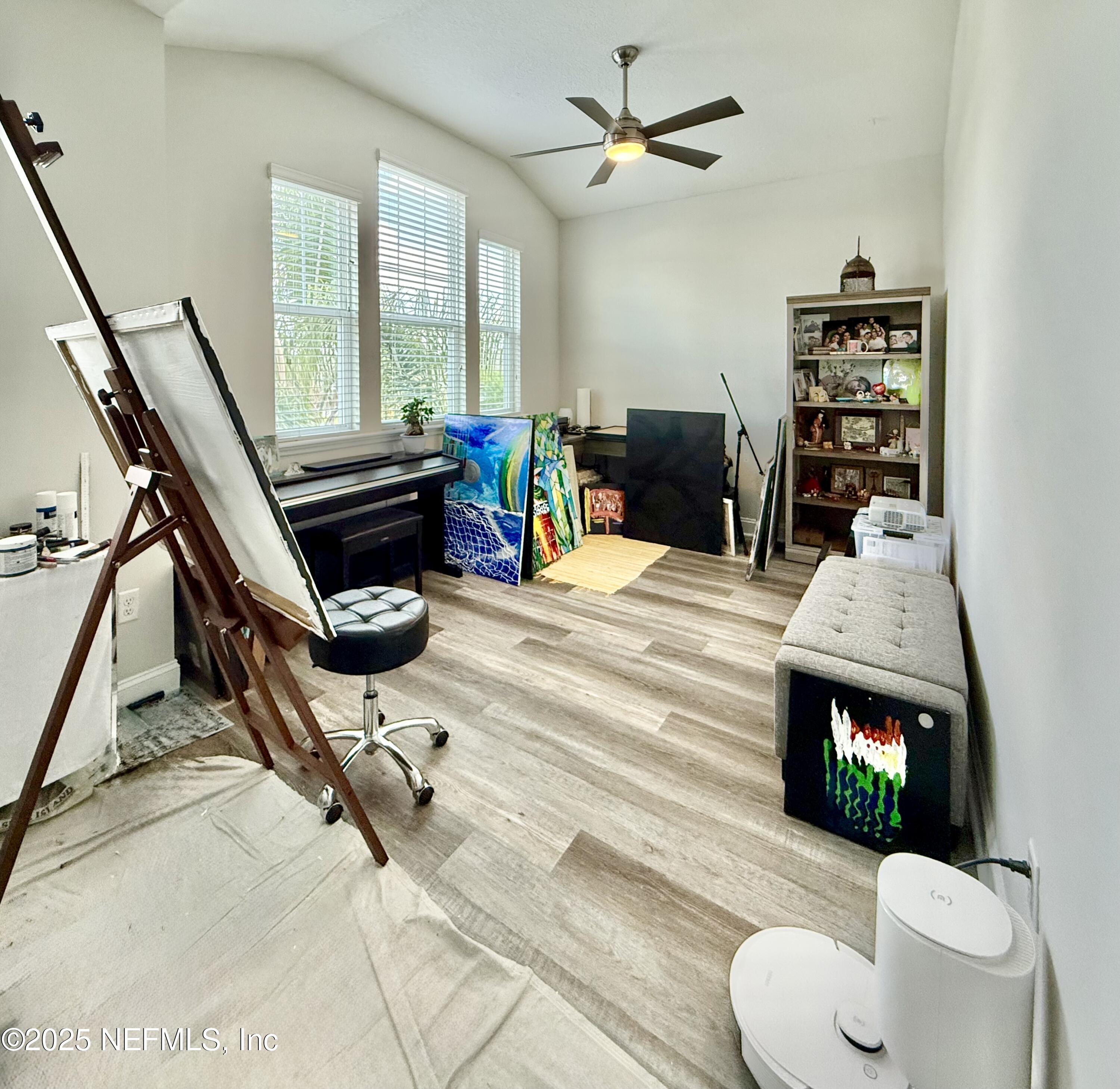 6887 Azalea Grove Drive Jacksonville, FL 32258 - Photo 25 of 35 a living room with furniture a fireplace and a flat screen tv