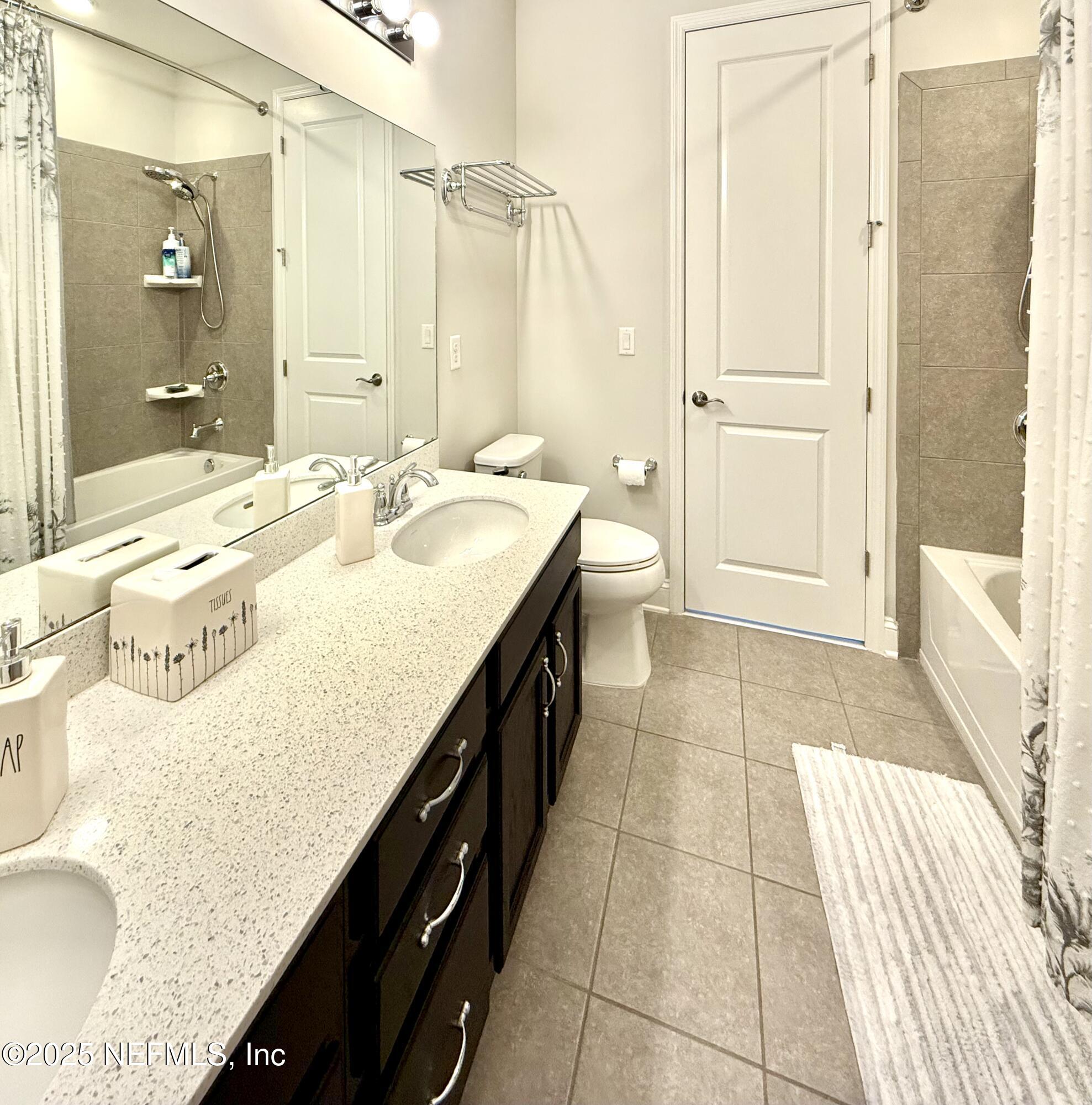 6887 Azalea Grove Drive Jacksonville, FL 32258 - Photo 27 of 35 a spacious bathroom with a granite countertop sink a mirror and a bathtub