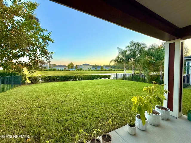 a view of a park with houses in the background