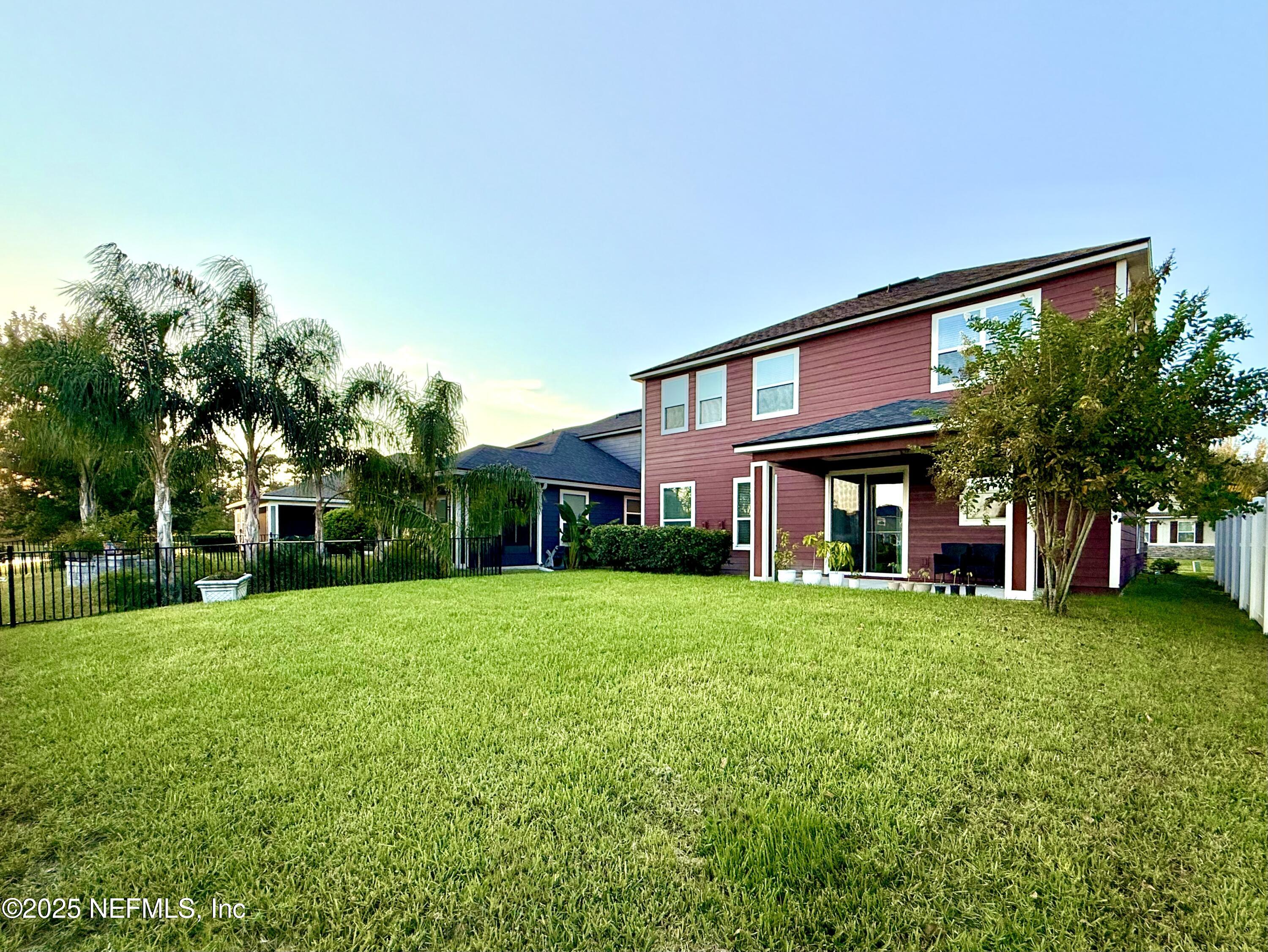 6887 Azalea Grove Drive Jacksonville, FL 32258 - Photo 34 of 35 a view of a house next to a big yard and large trees