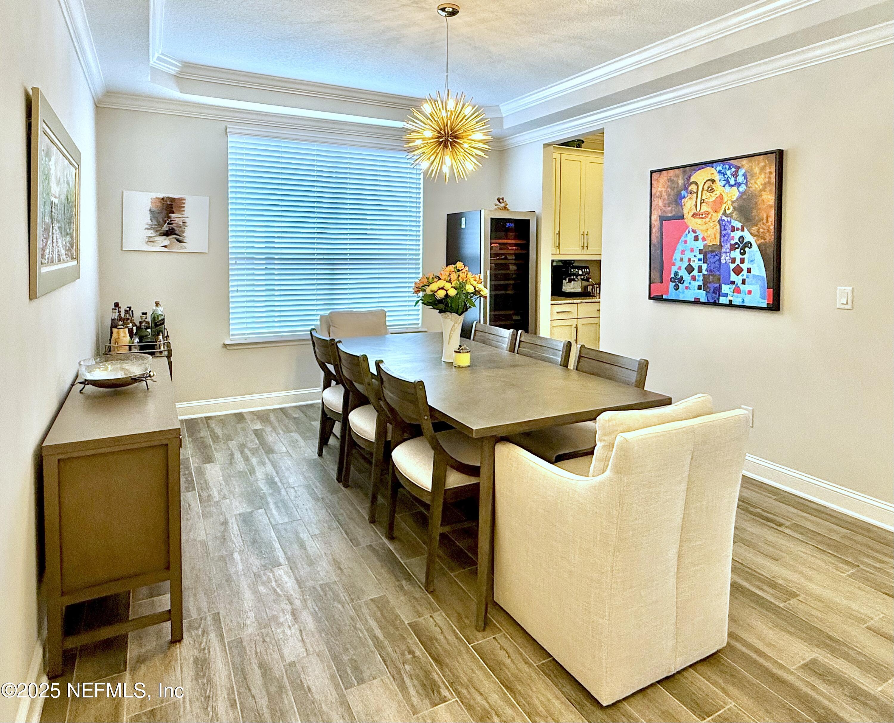 6887 Azalea Grove Drive Jacksonville, FL 32258 - Photo 6 of 35 a view of a dining room with furniture and wooden floor