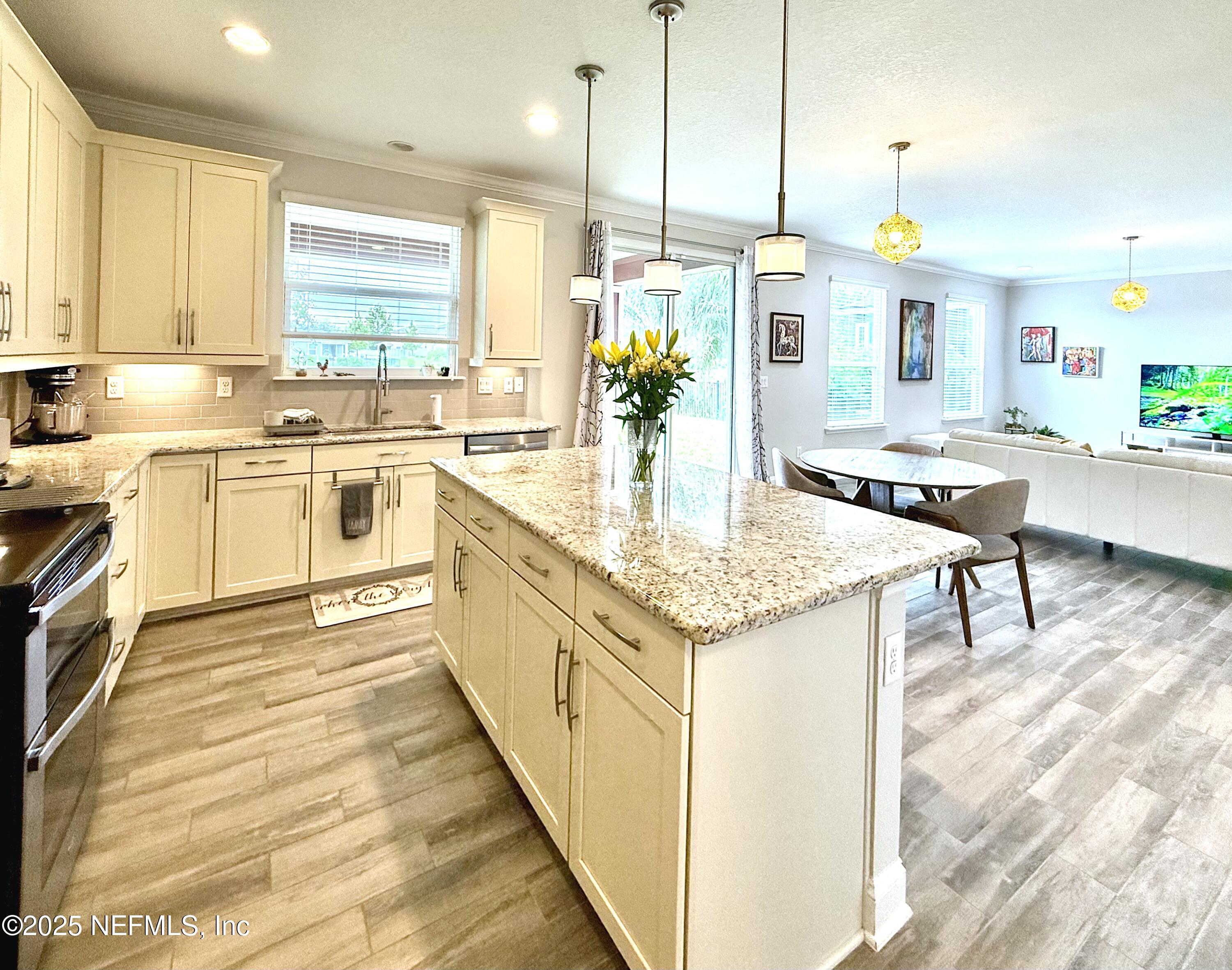 6887 Azalea Grove Drive Jacksonville, FL 32258 - Photo 8 of 35 a kitchen with kitchen island granite countertop wooden cabinets and white appliances