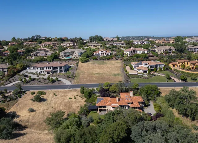 an aerial view of a house with a lake view