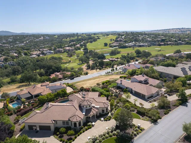 an aerial view of a city with lots of residential buildings and ocean view